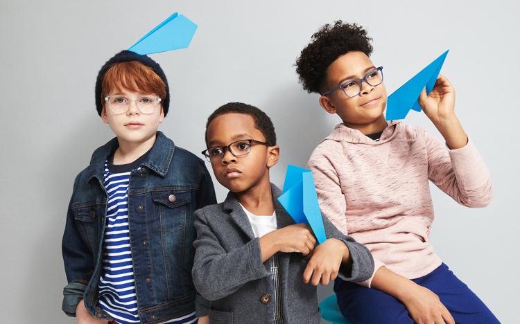 Boys posing with blue paper airplanes